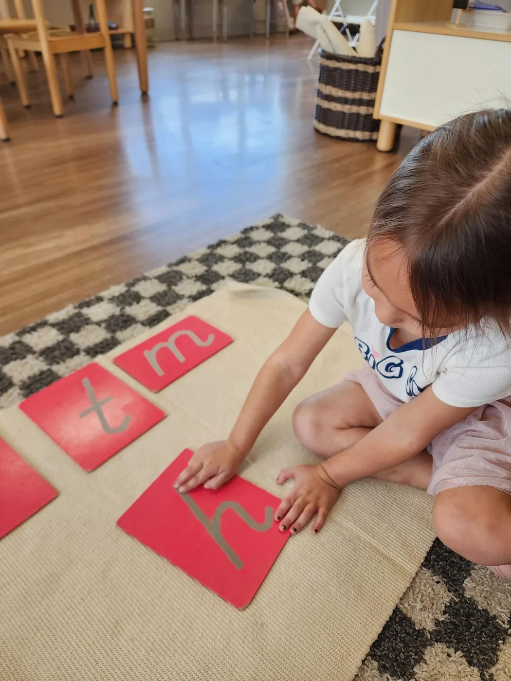 Early childhood student working with sandpaper letters